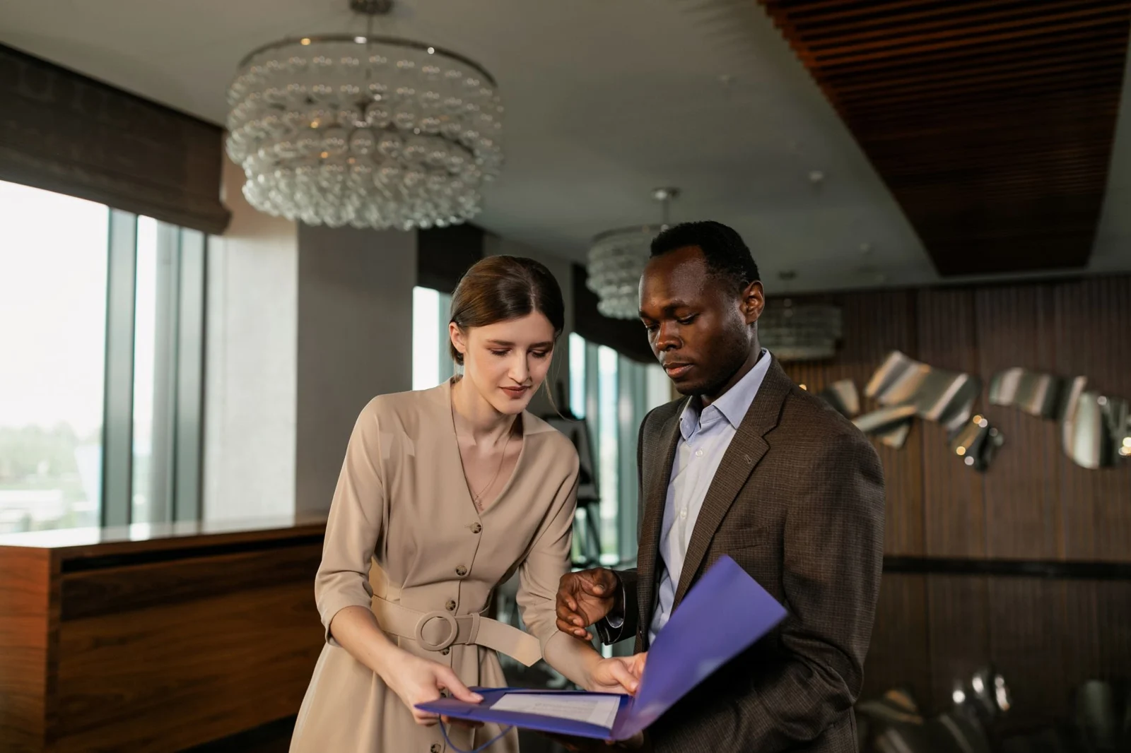 Two professionals reviewing a document together.